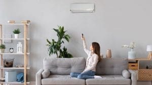 Woman turning on AC